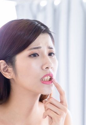 Woman checking her teeth in the mirror