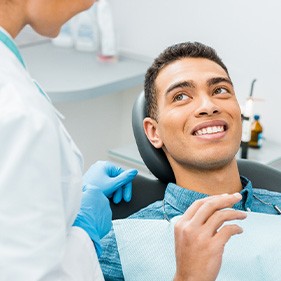 Patient smiling at reflection in mirror