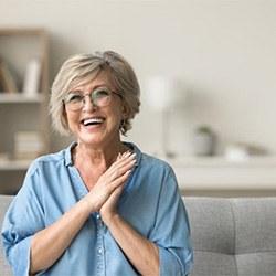 an older woman smiling comfortably while at home