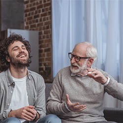 a grandparent speaking to his grandchild at home