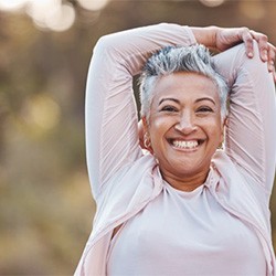 an older woman smiling before going on a jog