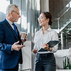 people in business wear speaking to each other