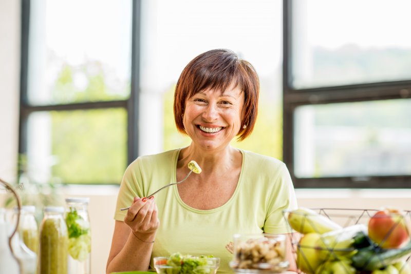 Patient smiling after receiving their dentures