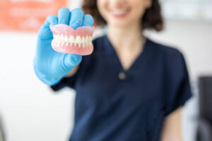 Dentist holding a set of dentures